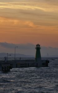 Preview wallpaper pier, lighthouse, sea, waves, sunset