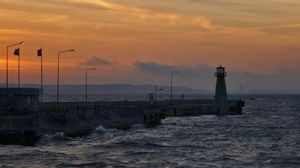 Preview wallpaper pier, lighthouse, sea, waves, sunset