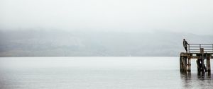 Preview wallpaper pier, man, loneliness, melancholia, lake, fog, water