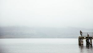 Preview wallpaper pier, man, loneliness, melancholia, lake, fog, water