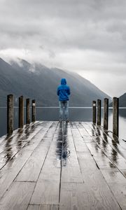 Preview wallpaper pier, man, mountains, alone, solitude