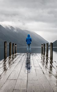 Preview wallpaper pier, man, mountains, alone, solitude