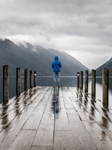 Preview wallpaper pier, man, mountains, alone, solitude