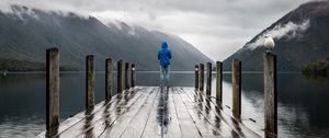 Preview wallpaper pier, man, mountains, alone, solitude
