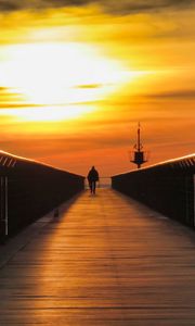 Preview wallpaper pier, man, silhouette, alone, sea, sunset