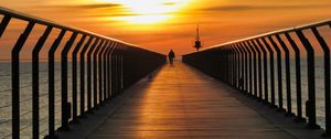 Preview wallpaper pier, man, silhouette, alone, sea, sunset