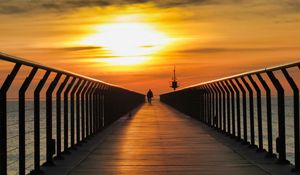 Preview wallpaper pier, man, silhouette, alone, sea, sunset