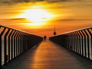 Preview wallpaper pier, man, silhouette, alone, sea, sunset