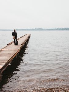 Preview wallpaper pier, man, suitcase, travel, kirkland, united states