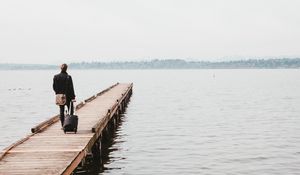 Preview wallpaper pier, man, suitcase, travel, kirkland, united states