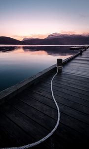 Preview wallpaper pier, mountains, lake, rope, sunset