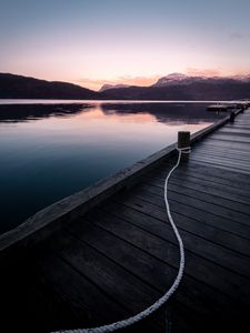 Preview wallpaper pier, mountains, lake, rope, sunset