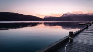 Preview wallpaper pier, mountains, lake, rope, sunset