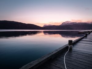 Preview wallpaper pier, mountains, lake, rope, sunset