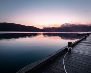 Preview wallpaper pier, mountains, lake, rope, sunset