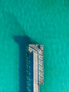 Preview wallpaper pier, ocean, shadow, top view, surface, turquoise