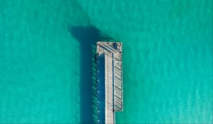 Preview wallpaper pier, ocean, shadow, top view, surface, turquoise