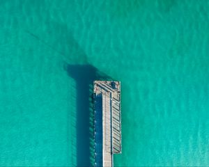 Preview wallpaper pier, ocean, shadow, top view, surface, turquoise