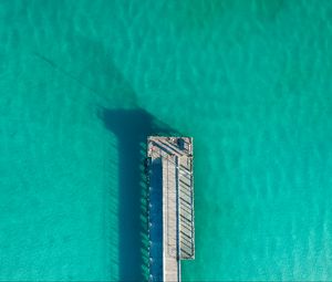 Preview wallpaper pier, ocean, shadow, top view, surface, turquoise