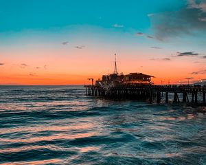 Preview wallpaper pier, ocean, surf, sunset, wave