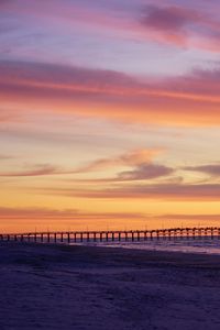 Preview wallpaper pier, pilings, sea, sunset, silhouette