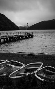 Preview wallpaper pier, river, mountains, boats, black and white