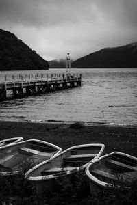 Preview wallpaper pier, river, mountains, boats, black and white