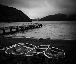 Preview wallpaper pier, river, mountains, boats, black and white