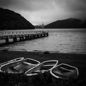 Preview wallpaper pier, river, mountains, boats, black and white