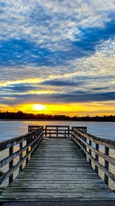 Preview wallpaper pier, river, sunset, sun