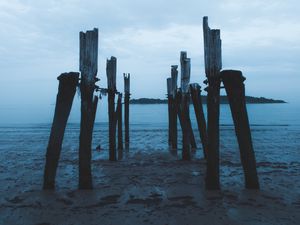 Preview wallpaper pier, ruins, sea, coast, night, twilight