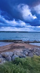 Preview wallpaper pier, sea, clouds, sky, stones