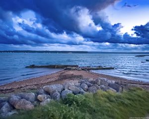 Preview wallpaper pier, sea, clouds, sky, stones
