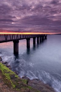 Preview wallpaper pier, sea, evening, clouds, stones, moss