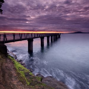 Preview wallpaper pier, sea, evening, clouds, stones, moss