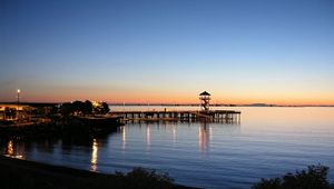 Preview wallpaper pier, sea, evening, decline, fires, coast, horizon