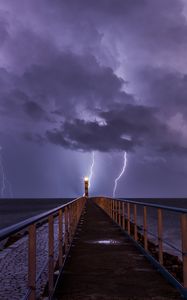 Preview wallpaper pier, sea, lighthouse, lightning, thunderstorm, dark