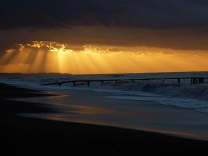 Preview wallpaper pier, sea, waves, light, beams