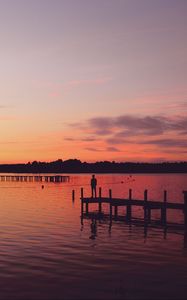 Preview wallpaper pier, silhouette, sunset, lake, loneliness