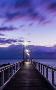 Preview wallpaper pier, sunset, horizon, sea, lilac, clouds