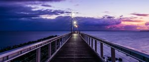 Preview wallpaper pier, sunset, horizon, sea, lilac, clouds