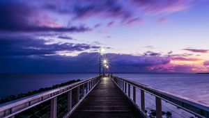 Preview wallpaper pier, sunset, horizon, sea, lilac, clouds
