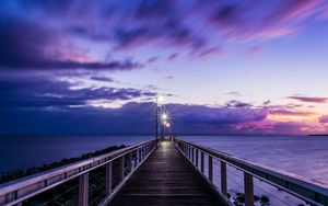 Preview wallpaper pier, sunset, horizon, sea, lilac, clouds