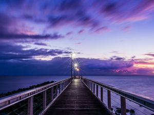 Preview wallpaper pier, sunset, horizon, sea, lilac, clouds
