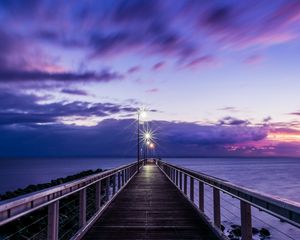 Preview wallpaper pier, sunset, horizon, sea, lilac, clouds