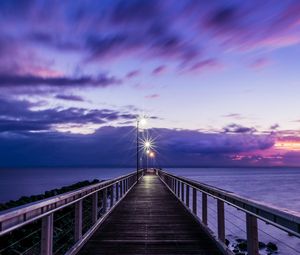 Preview wallpaper pier, sunset, horizon, sea, lilac, clouds