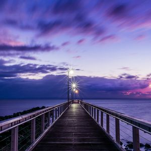 Preview wallpaper pier, sunset, horizon, sea, lilac, clouds