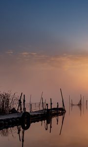 Preview wallpaper pier, sunset, lake, fishing nets