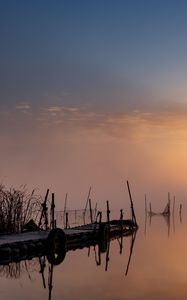 Preview wallpaper pier, sunset, lake, fishing nets