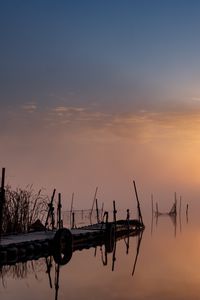 Preview wallpaper pier, sunset, lake, fishing nets